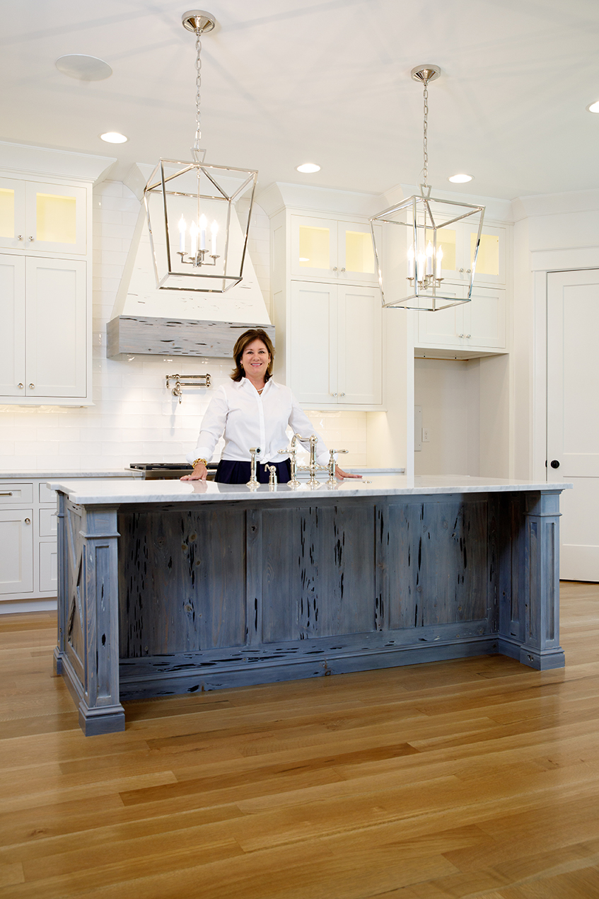 Woman standing at an island in kitchen